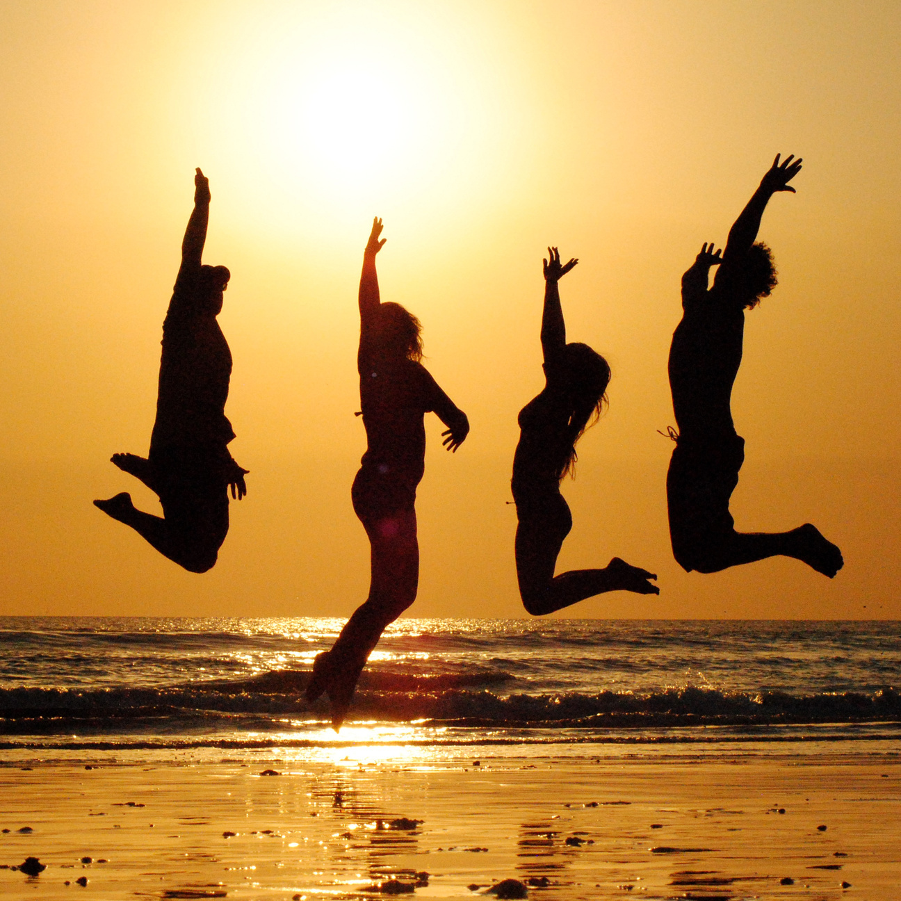 Friends Jumping at Beach